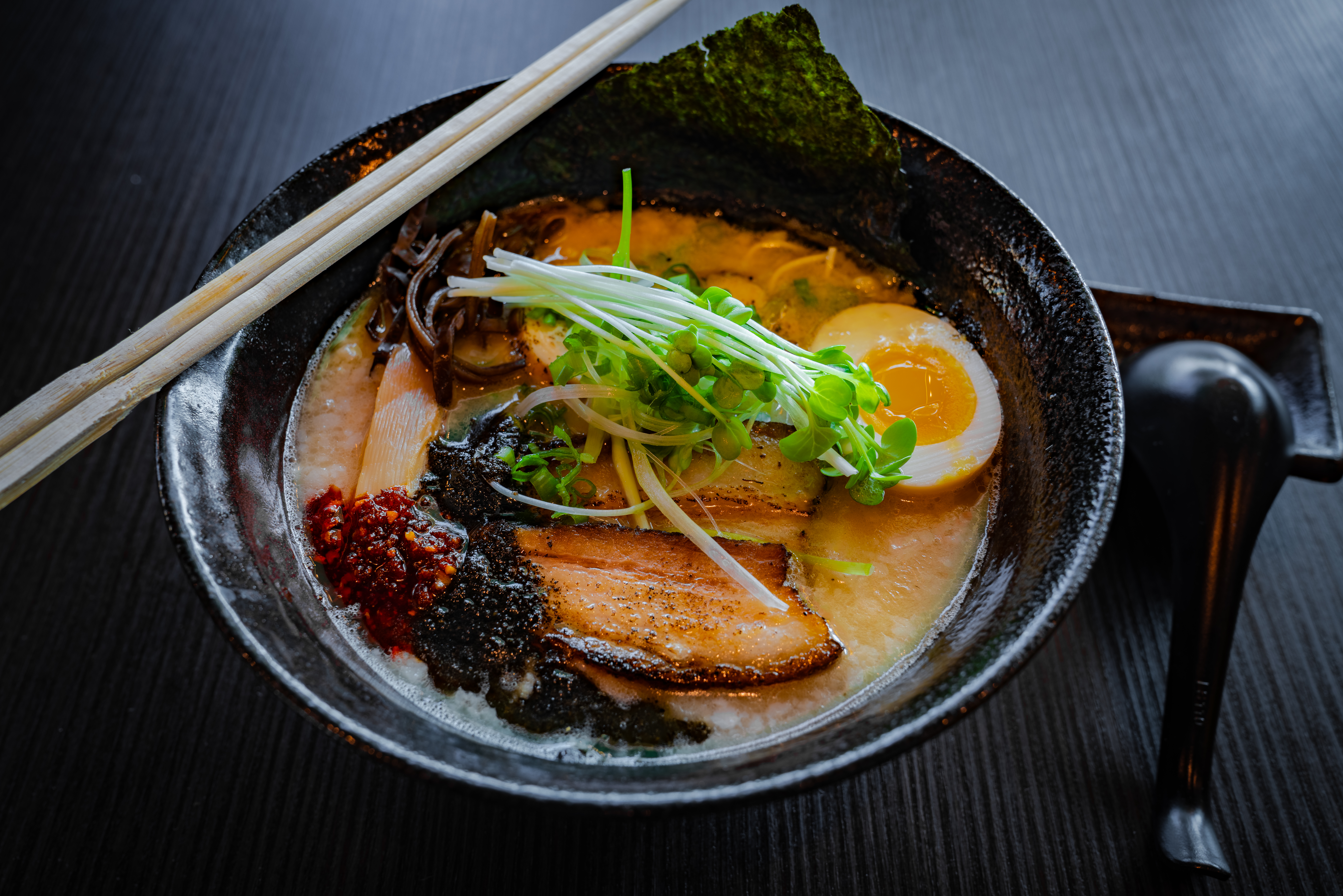 ramen in bowl with chopsticks and spoon
