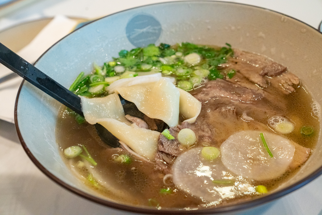 beef soup and noodles in bowl