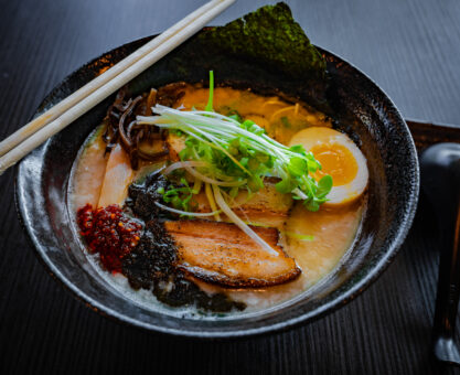 ramen in bowl with chopsticks and spoon