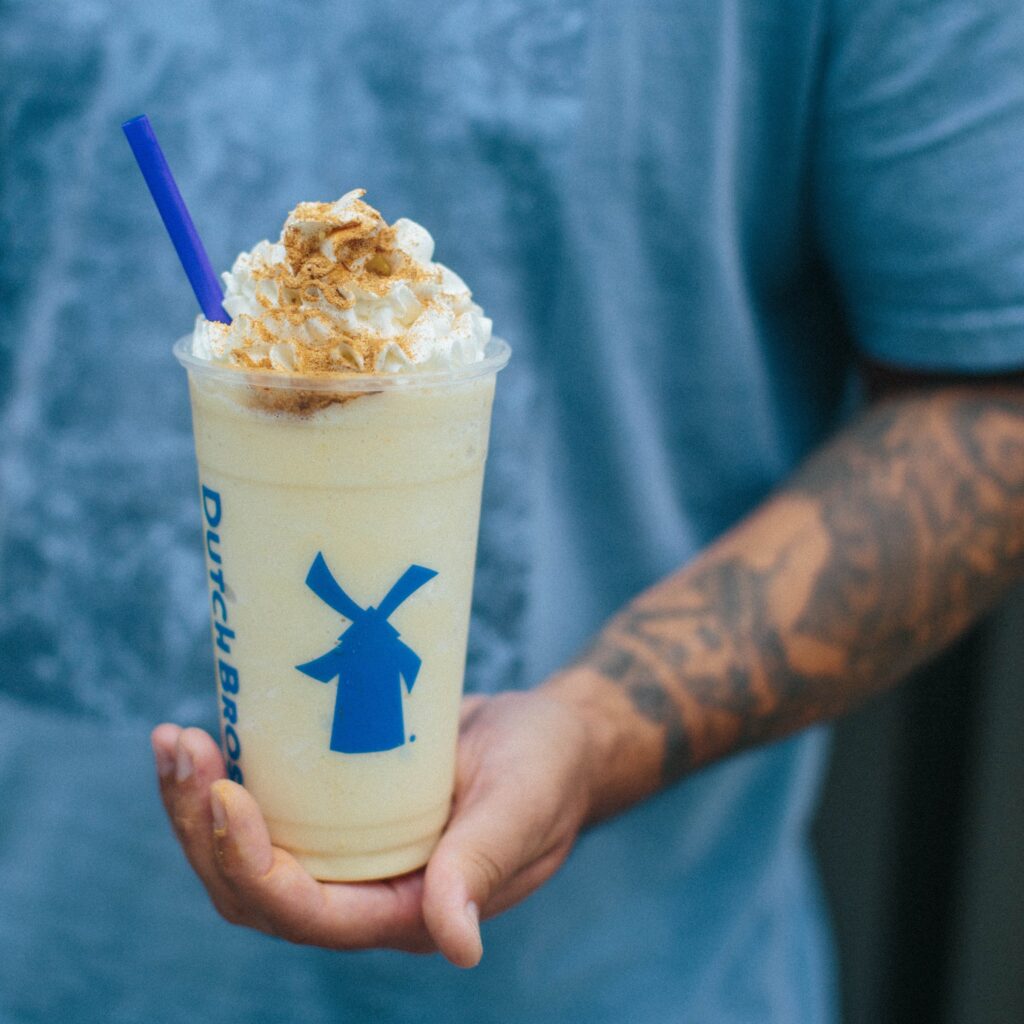 Holding a Dutch Bros drink in one hand