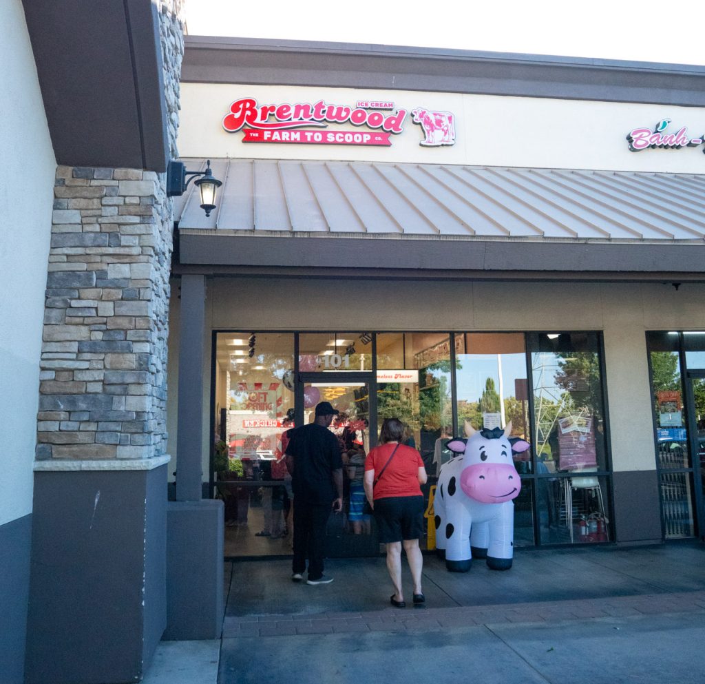 Front of Brentwood Ice Cream Co with a line of people during their soft opening