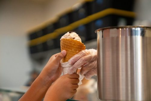 Handing over ice cream cone to a customer